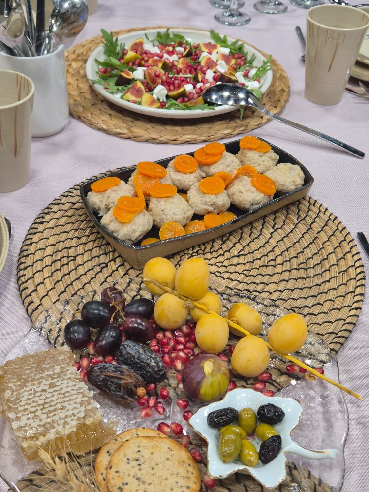 Seven species decorated plate (wheat barley fig date olive grape pomegranate), gefilte fish, fig salad 