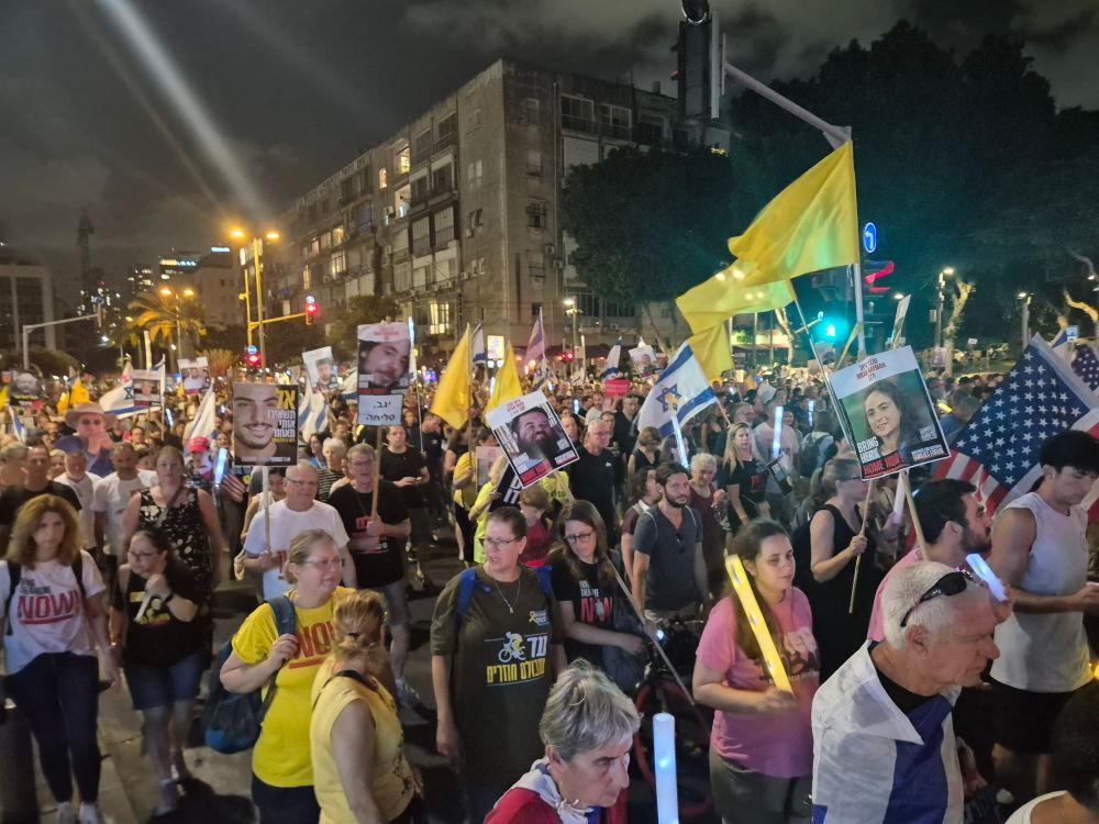 ~50k people marching through the streets of Tel Aviv from Hostages Square, waving Israel, US and yellow flags. 