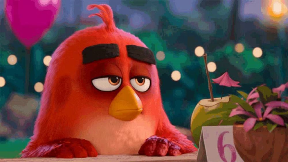 a red angry bird sits at a table with a sign that says 6 on it