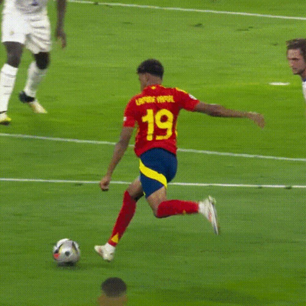 a soccer player with the number 19 on his jersey kicks the ball