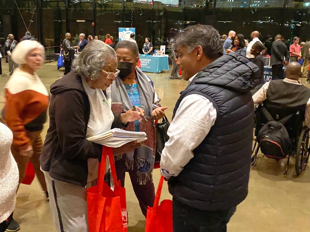 Danny in a puffer vest talking with two ladies about Civic Associations.