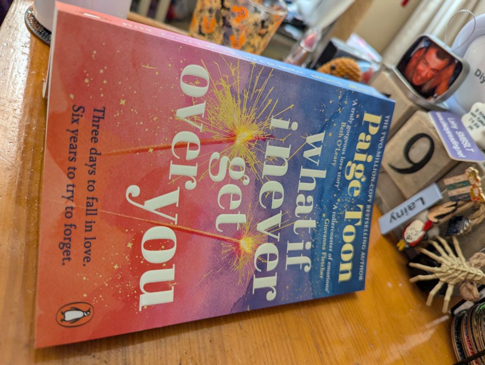 What if I never get over you by author paige toon. Book opened flat on a wooden table 