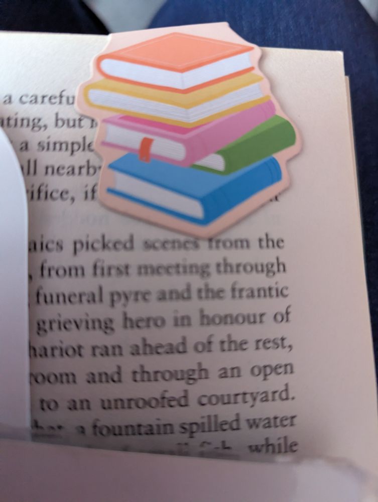 Magnetic bookmark, small coloured stack of books attached to the page. 