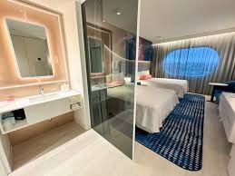 Picture belongs to https://www.threads.net/@brookegmcdonald/post/DFLTLtevXaP?xmt=AQGzvJVZdC2wKIqg71uNN1gn1g3PCfyostScvzMIKYYG7g

A bathroom from the Stella Nova Hotel at Universal Resort, Orlando. The photos shows the bathroom being fully open with just a curtain in front of it. 