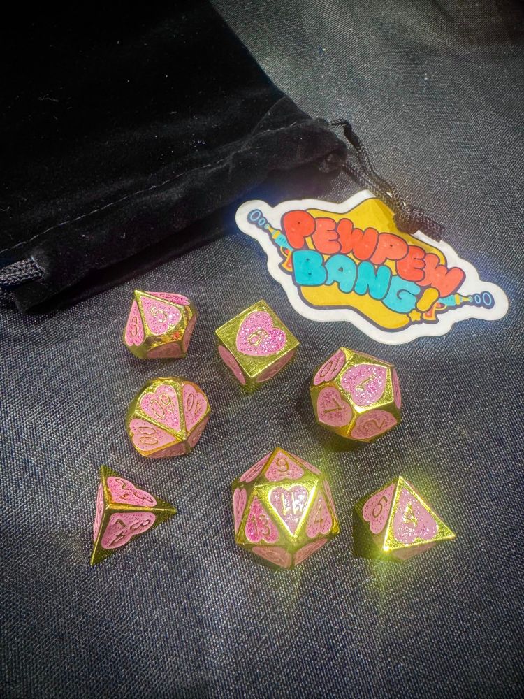 some very girly sparkly pink metal dice
