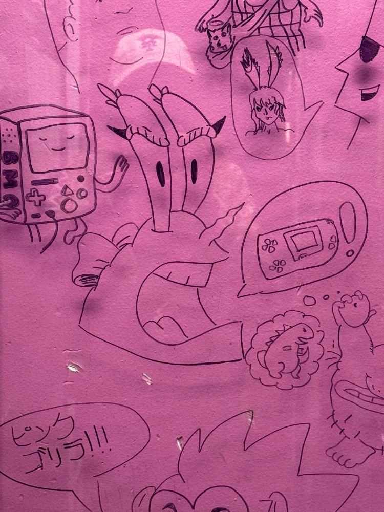 A sharpie drawing of Mr Krabs with winged eyeliner and a bow, with a speech bubble that just has a wonderswan in it