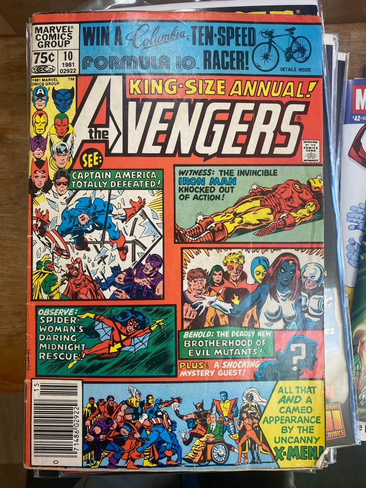 Alt text: The cover of Avengers Annual 10 from 1981. The cover features several panel-style images rather than the standard single image. Three of them feature Avengers (Captain America, Iron Man, and Spider-Woman) and the final two feature Marvel mutants. One has the Brotherhood of and the other features the X-Men facing off against the Avengers. There is also a small silhouette, which is if the head and shoulders of someone who appears to be a woman. Next to that are the words, “Plus: a shocking mystery guest!” This refers to Rogue, who would go on to become a member of the X-Men.