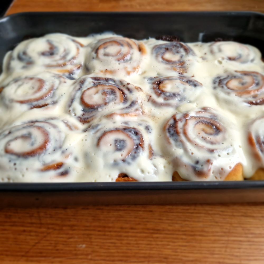 A casserole dish full with untouched cinnamon rolls (3x4 to be exact).