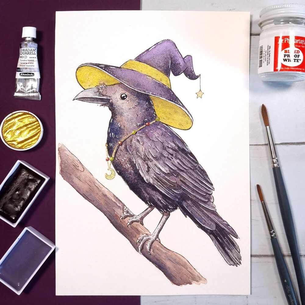 watercolor painting of a raven wearing a witch hat painted in granulation watercolours, paints on the left of image and paint brushes on the right