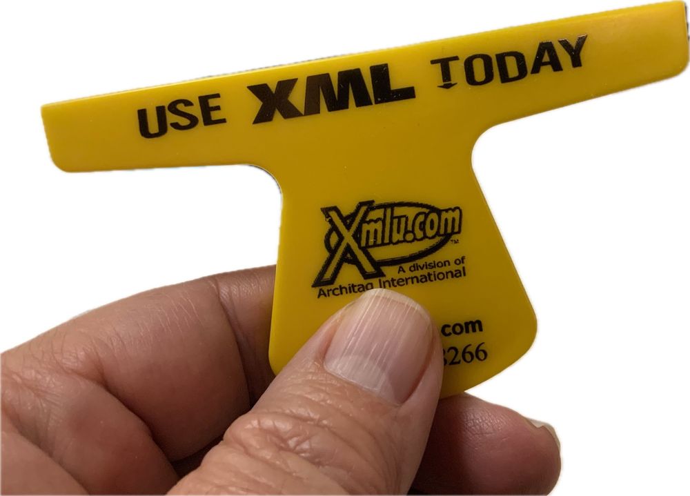Fingers holding a small yellow squeegee (a computer screen cleaning tool) that says "USE XML TODAY."