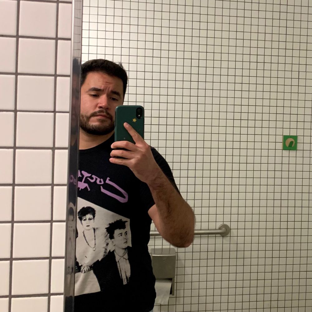 Mirror selfie. I’m in a white tiled restroom. 