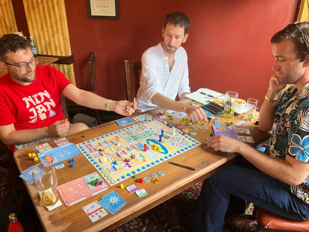 Three playtesters enjoying a game prototype with a pirate theme. 