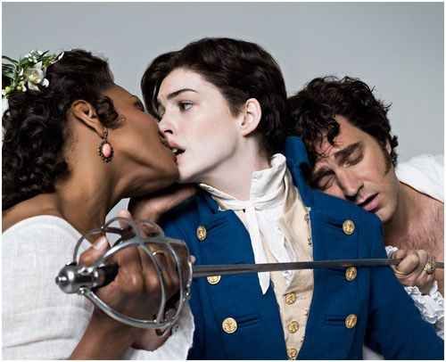 anne hathaway picture where shes kissing the girl in the twelfth night and theres the guy in the back and its gay and kinda poly i think i dont know i just like the picture