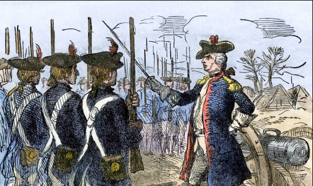 Illustration of von Steuben training Patriot troops. They stand before him in their rank, with rifles at "present arms" while he is facing them, holding his sword up as if making a point. Behind him are other troops in their ranks and in the background tents neatly aligned in good military order.
