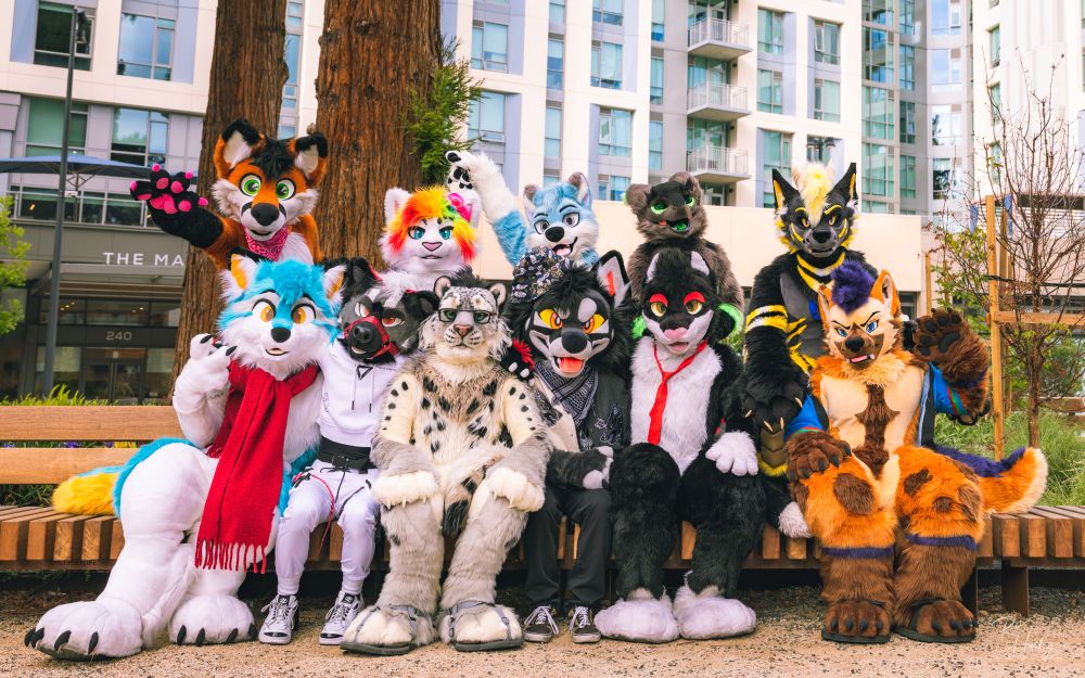 Group of fursuits on a bench 