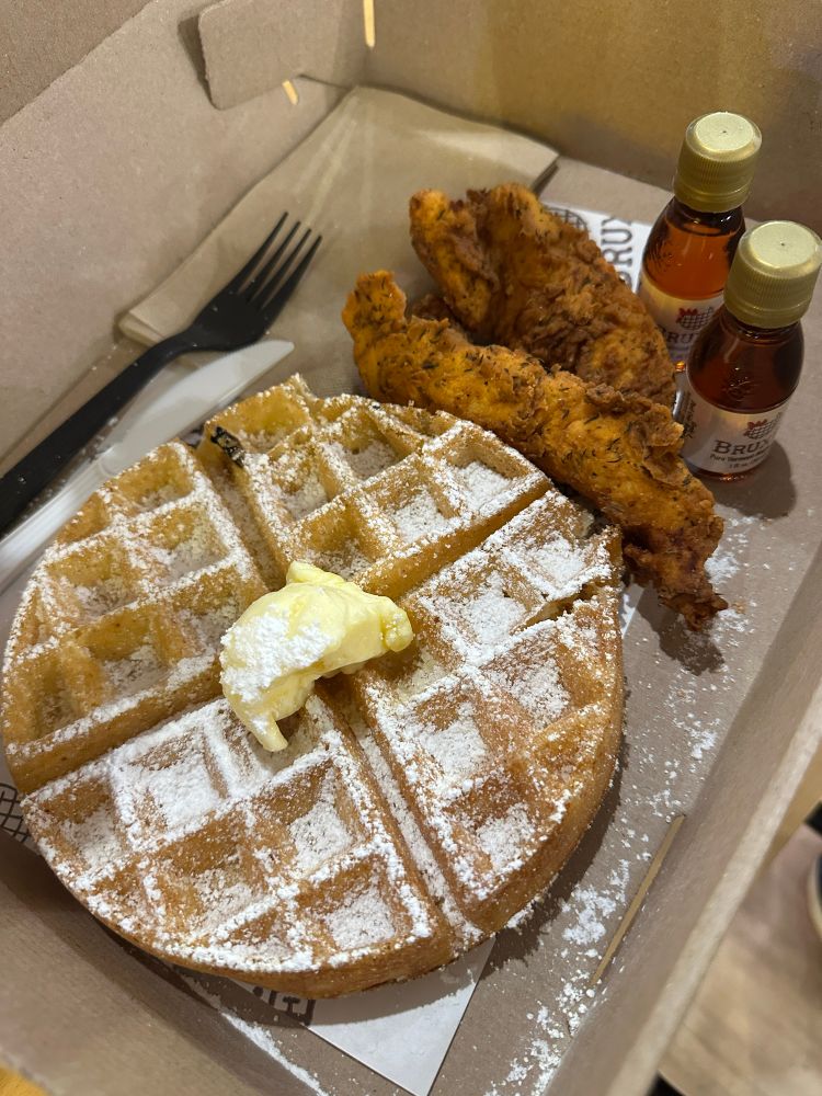 Chicken and waffles with maple syrup and butter