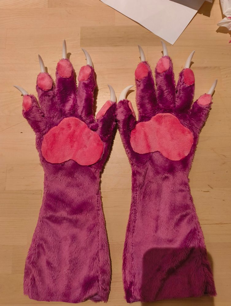 2 Mauve purple 5 fingered paws with 3d printed claws, face up, with bright pink paw pads.