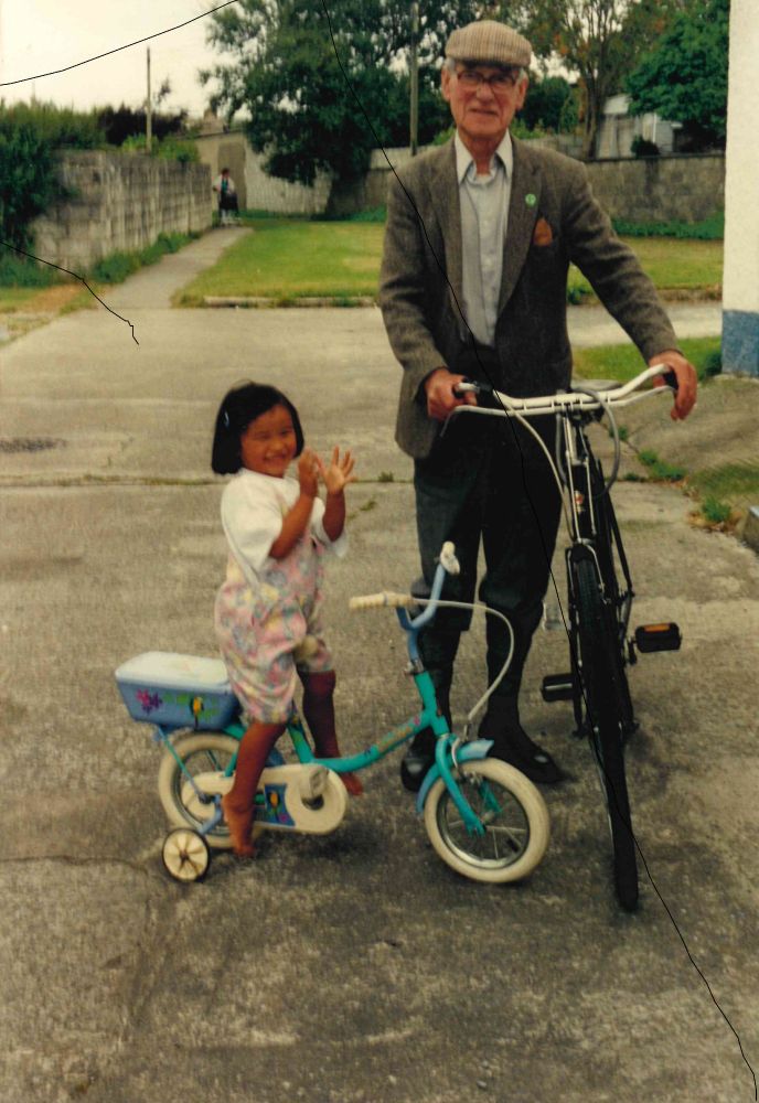 Úna-Minh and her Grandad on bikes