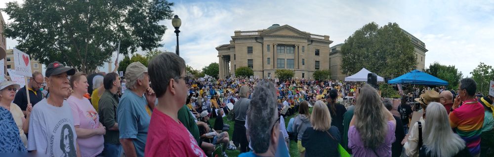 Panorama view of large crowd with Boone County Courthouse in background