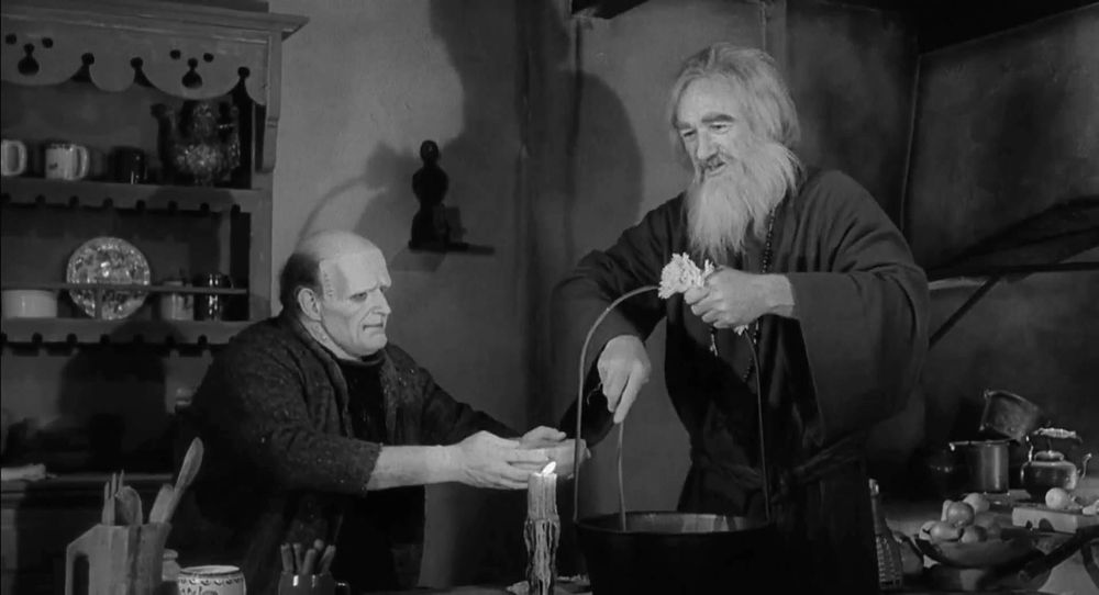 A black and white still of actor Peter Boyle as The Monster trying to eat soup with actor Gene Hackman as The Blind Hermit in YOUNG FRANKENSTEIN (1974)