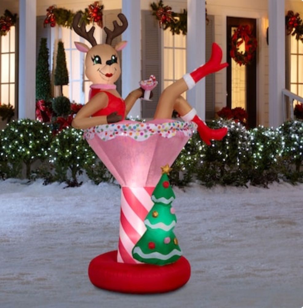 A Christmas inflatable for the front yard with a female reindeer in a martini glass done up like a classic burlesque performer.