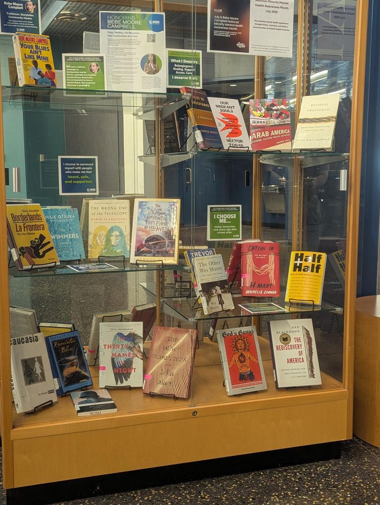 A glass case filled with books