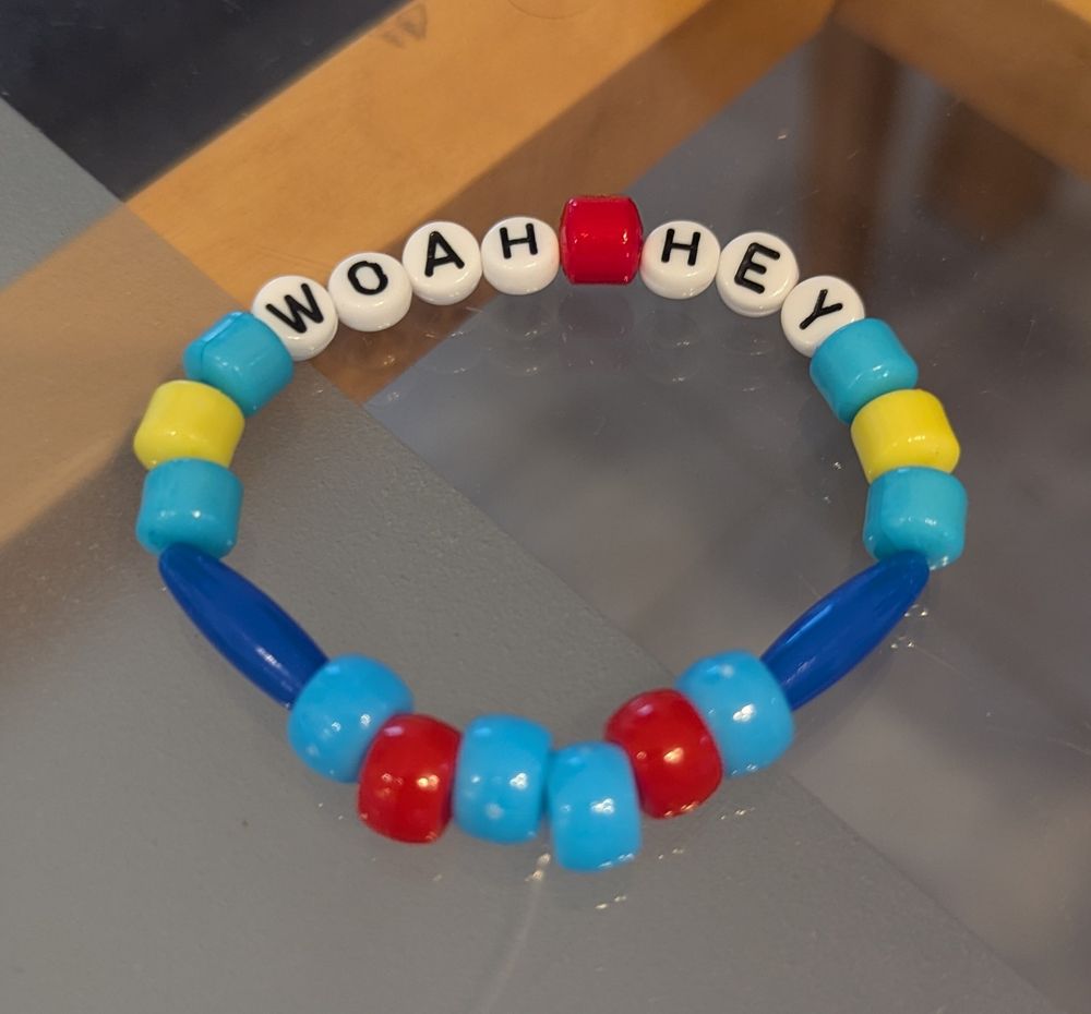 Marcille themed bracelet with her colour pallet and the words "woah hey"