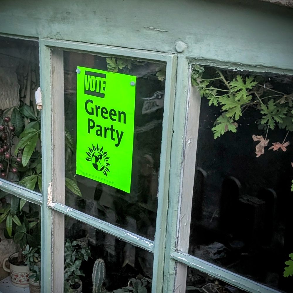 A poster on luminous green paper that says "Vote Green Party".