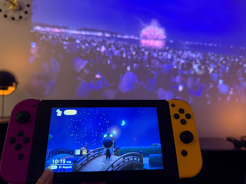 Date night at the summer fireworks in Animal Crossing New Horizons and actual Kamakura summer fireworks on YouTube in the background.