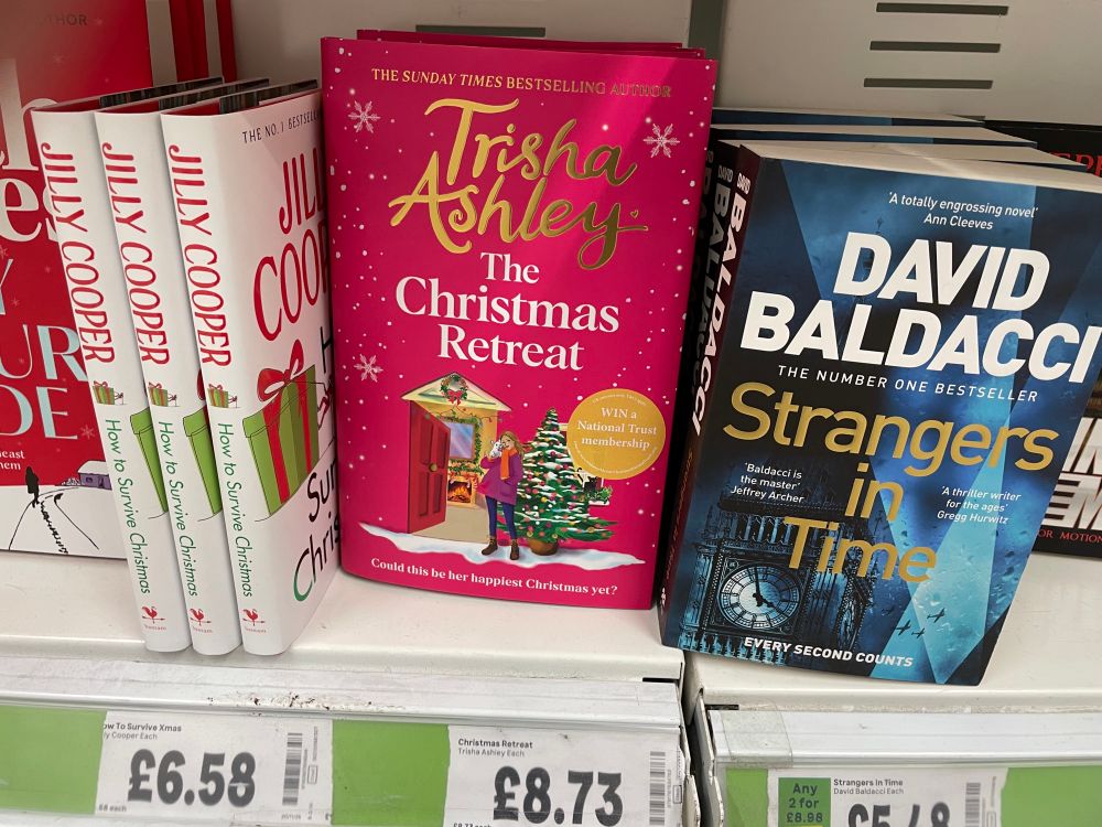 book cover of The Christmas Retreat by Trisha Ashley on an Asda book shelf 