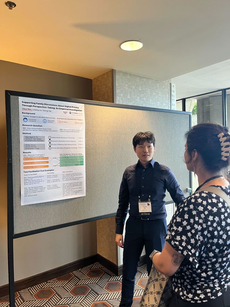 Zikai is standing in front of his research poster, discusses his research project with another researcher during the Q&A sesssion.