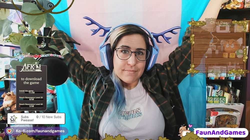 nonbinary Twitch streamer FaunAndGames is wearing a shirt that says "Trans Rights!" and holding up a trans pride flag.
