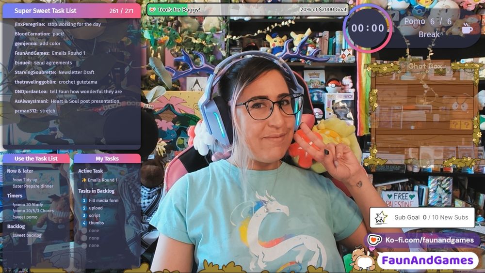 Nonbinary streamer FaunAndGames, a tan skin femme perceived person with brown, blue, and purple hair, is wearing gaming headphones with antlers on them. They are smiling at the camera and making a peace sign. Around them is a Twitch coworking stream setup featuring Super Sweet Bot. Shows a task list and other co-working applications.
