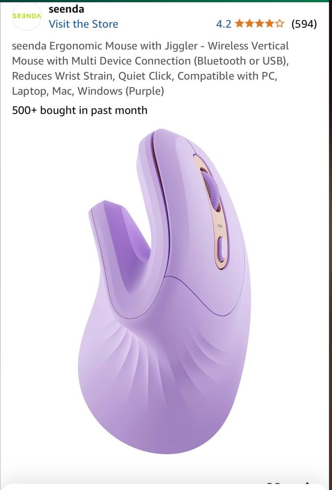 Photo features a purple ergonomic wireless computer mouse in a shape that resembles a sex toy.