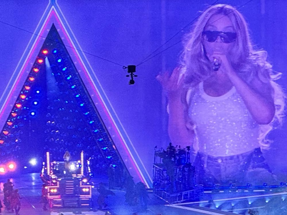 Beyoncé at the Cowboy Carter tour standing on a truck. 