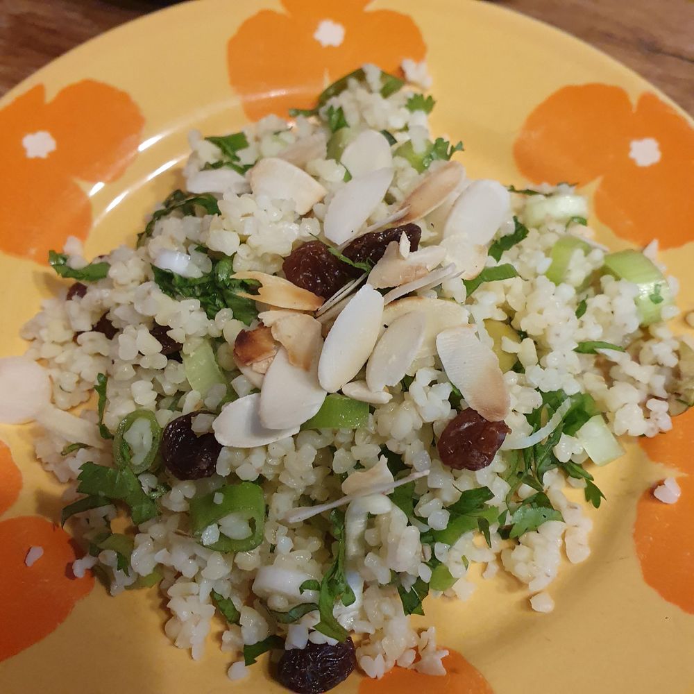 Bulgur with raisins, olives, herbs (coriander and mint) and spring onions, topped with roasted almond slices. 