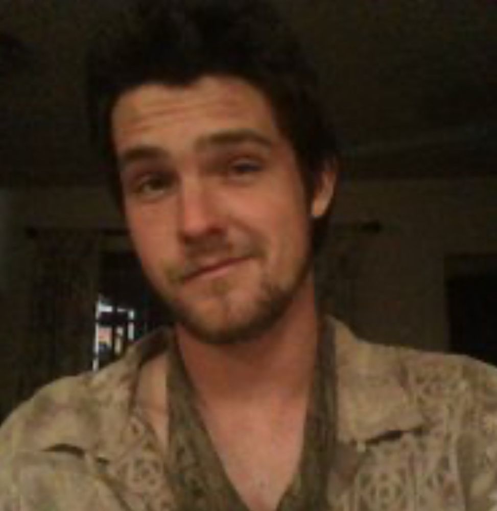 Photo of rapist from years ago in some pirate type clothes. I’m not sure what to call them. He’s got shorter hair and a smirk