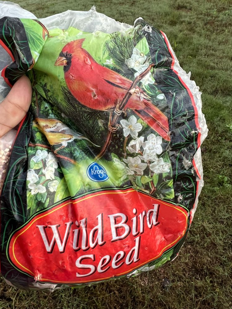 Bird seed bag with visible bite marks and tears 
