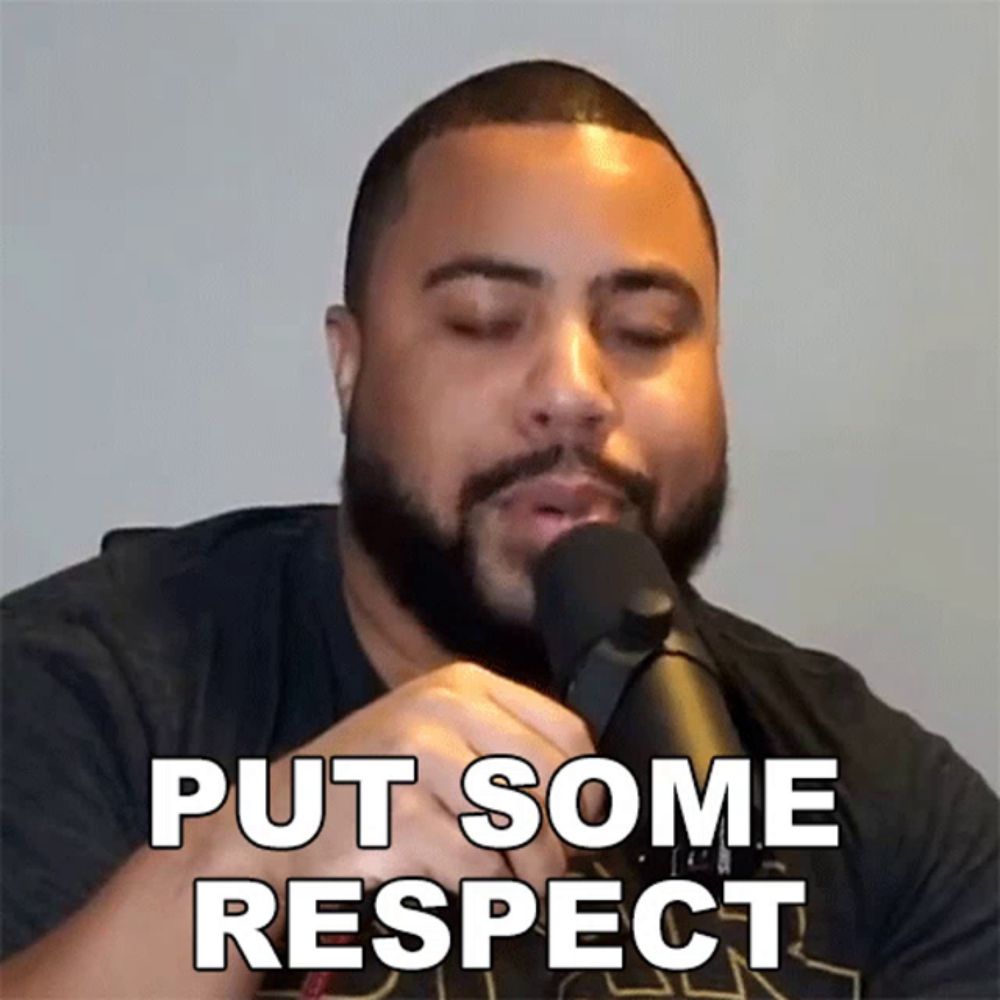 a man with a beard is singing into a microphone with the words put some respect written above him