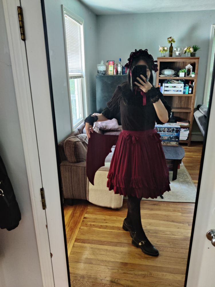 Burgundy Lolita skirt with fabric bat wings attached to the back
