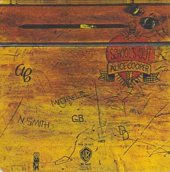 Alice Cooper School’s Out album cover: a wooden school desk with names and scratches