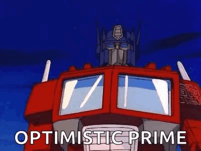 optimus prime from the transformers is standing in front of a blue sky and says `` optimistic prime '' .