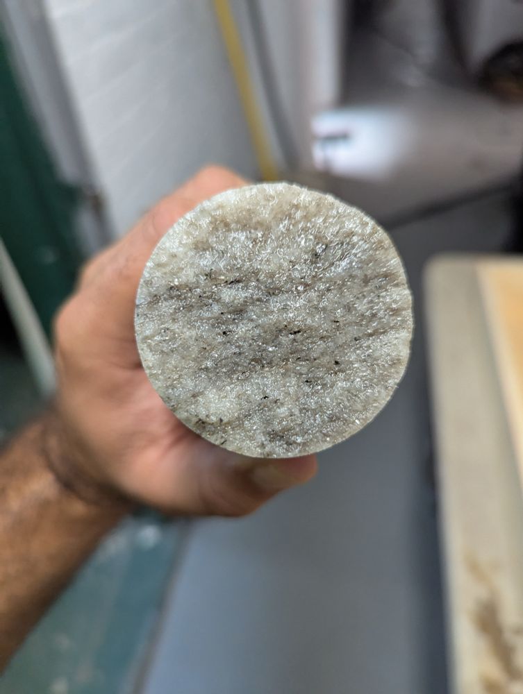 View of the top of one of the cores showing there's still some banding of the mica within the quartz and also some specs of a small black mineral that's probably biotite or hornblende 