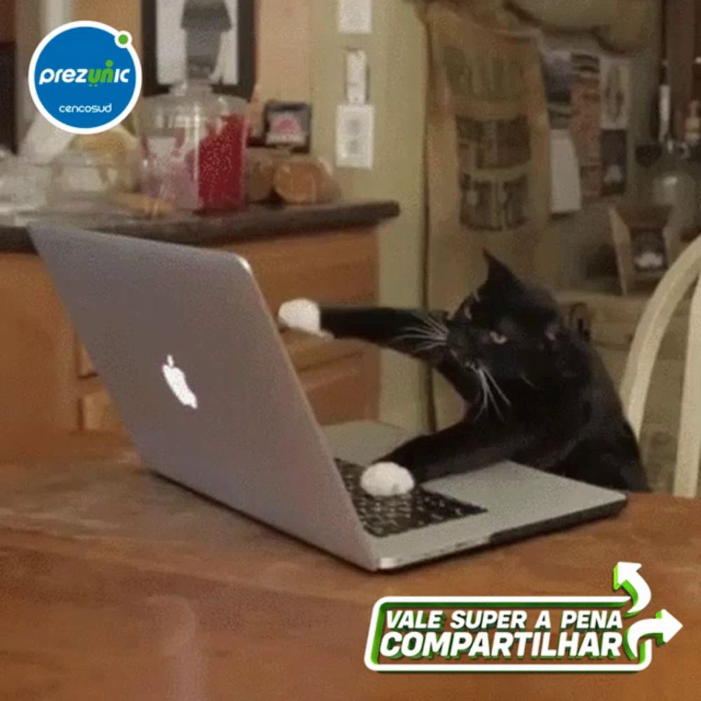 a cat is using an apple laptop with a sticker that says preziptic on it