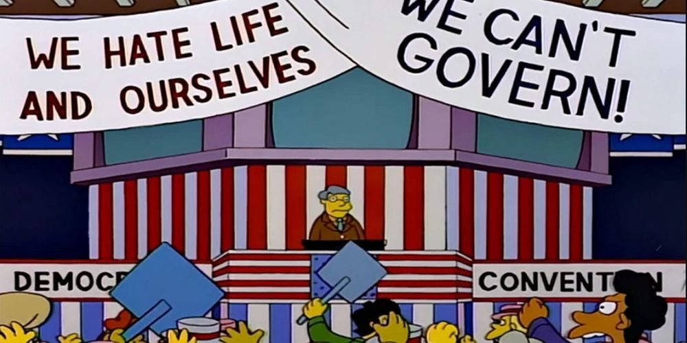 Screenshot from The Simpsons showing a Democratic Party convention where the banners read “We can’t govern!” and, to the point, “We hate life and ourselves”
