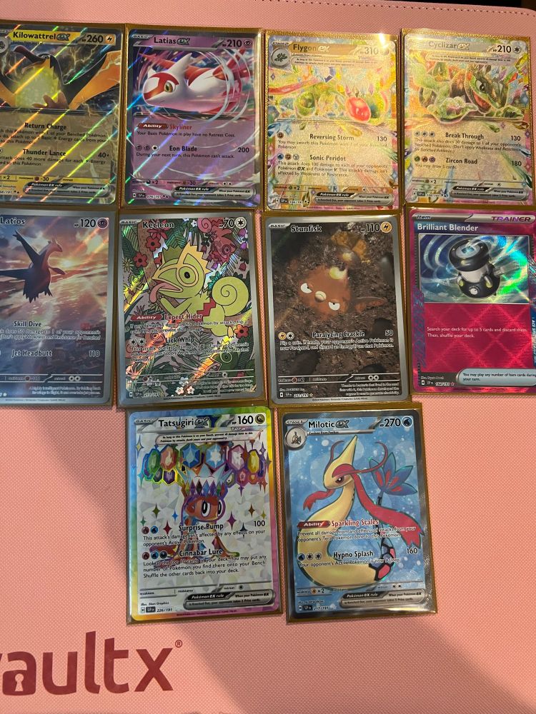 The hit cards from 2x Surging Sparks Elite Trainer Boxes.

Killowatrell Ex, Latias Ex, Flygon Ex, Tatsuguri Ex Full Art, Cyclizar Ex, Latios Illustration Rare, Kekleon Illustration Rare, Stunfisk Illustration Rare, Milotic Ex Full Art, Brilliant Blender Ace Spec.

All pictured on a pink background.