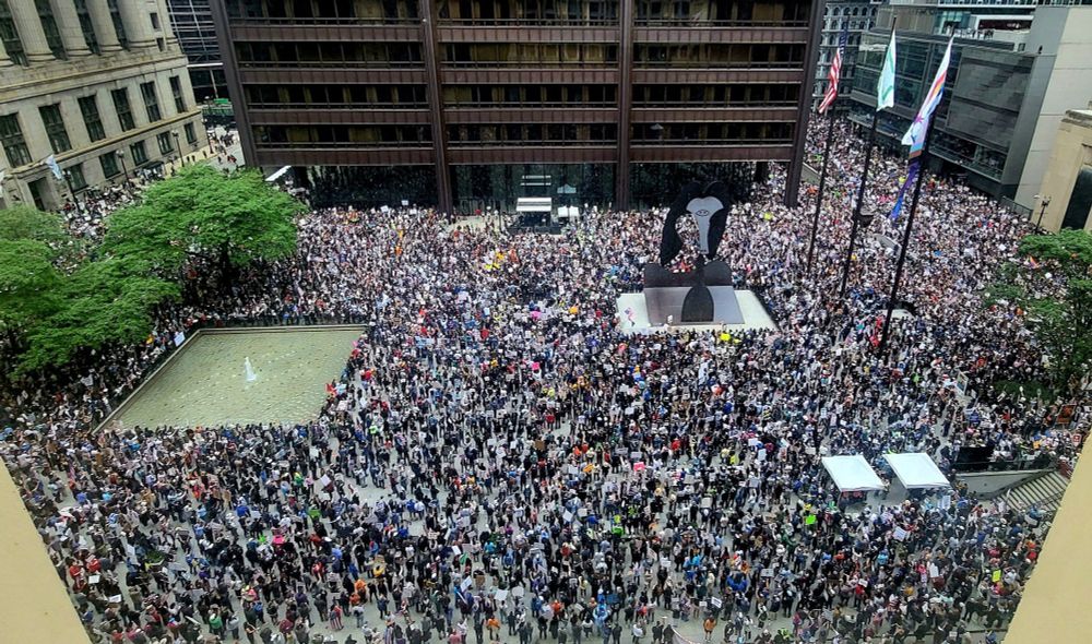 A photo from a building looking over Daley Plaza which is crammed with protestors, covering almost every square metre