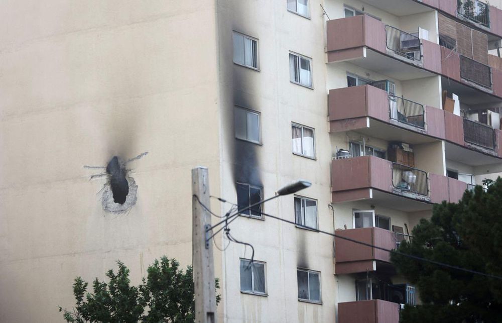 A picture of the apartment building in Tehran where Hossein Salami, commander of the Iranian Revolutionary Guard, was killed. The building shows a hole in the side and scorch marks where a bomb drone has apparently hit. The window of the apartment shows smoke from flames. Almost no other building is damaged, not even the windows broken. Photo credit to Alpha Defense.