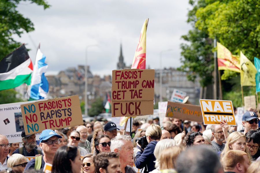Protestors seen holding signs in Edinburgh. Two say:
NO FASCISTS NO RAPISTS NO TRUML
FASCIST TRUMP CAN GET TAE FUCK