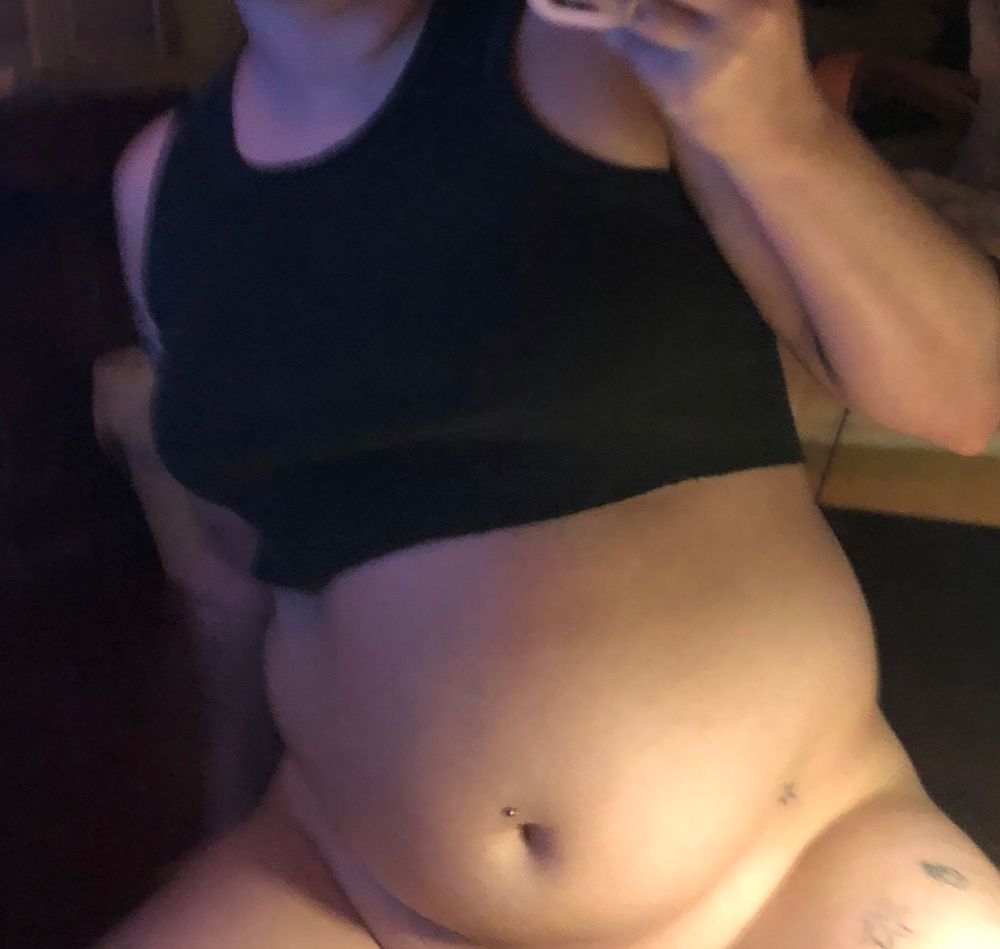 dawn poses in front of their mirror in just a cropped black tank top with their tummy and thighs showing. the photo is meticulously cropped to end where their pussy begins ;)